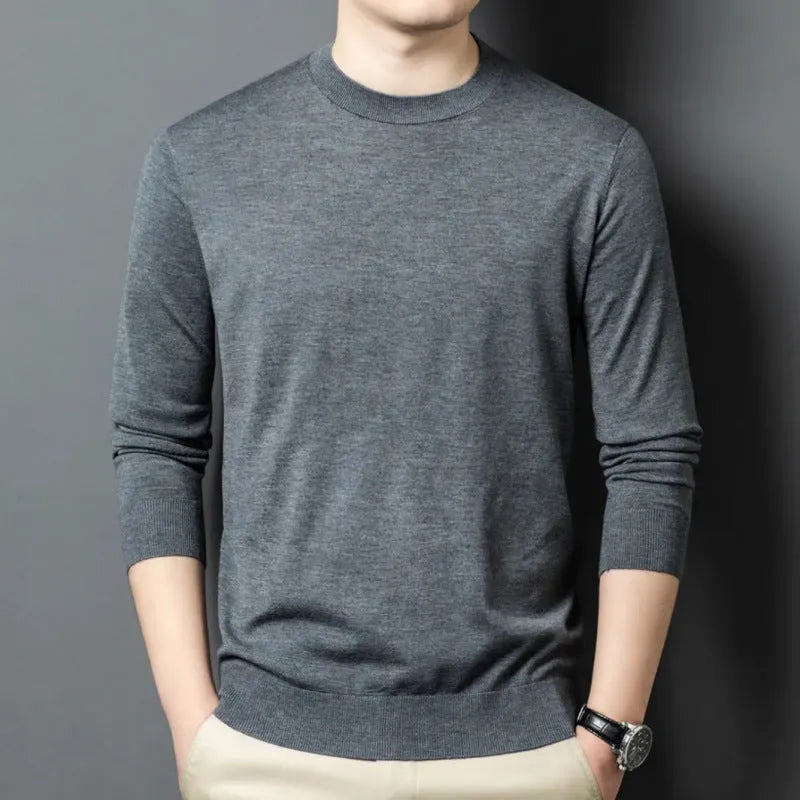 Men's round neck wool pullover sweater in a neutral colour with long sleeves, laid flat.
