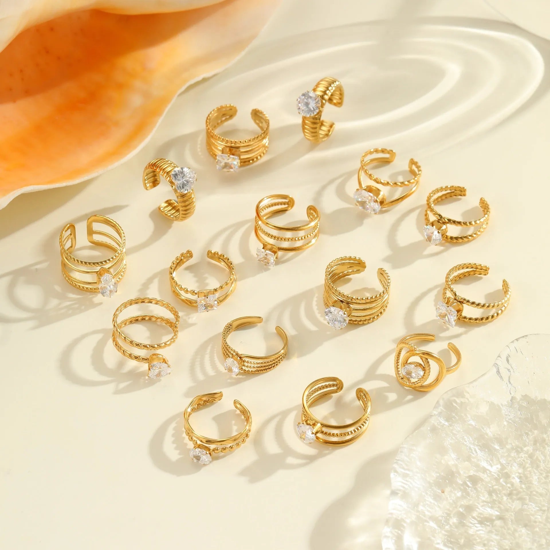 Gold-coloured stainless steel open ring with zircon stones in a geometric heart design.
