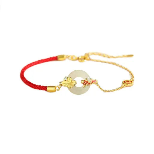 Women's red rope bracelet with silver and gold peace buckle charm featuring koi fish design
