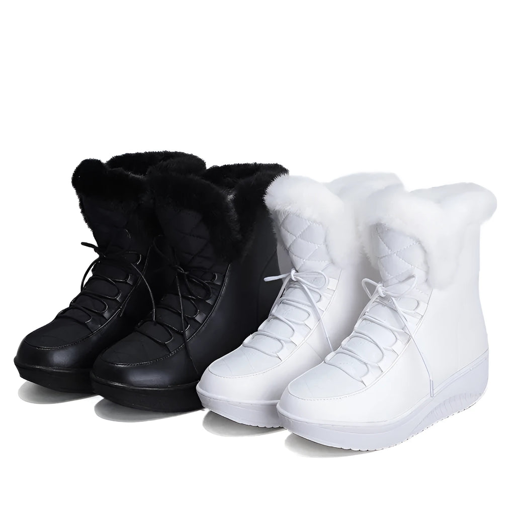 Black women's lace-up winter ankle boots with a platform sole on a white background