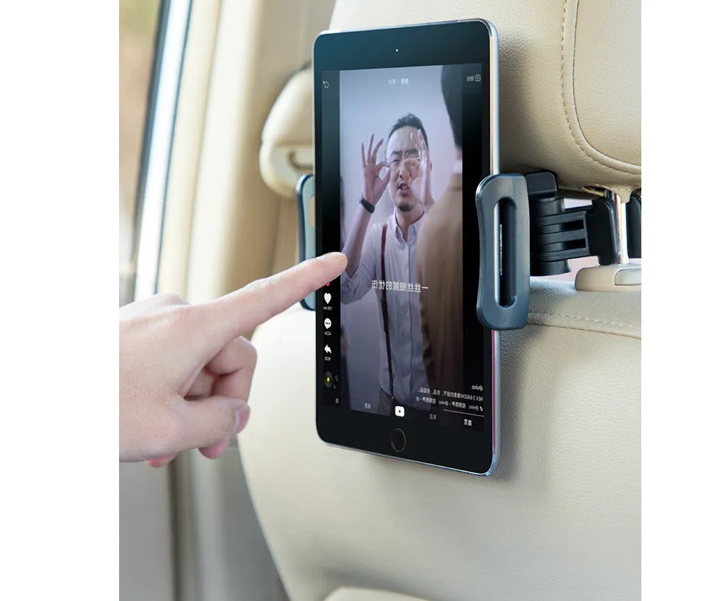 Black car phone holder mounted on vehicle rear seat base holding tablet for navigation