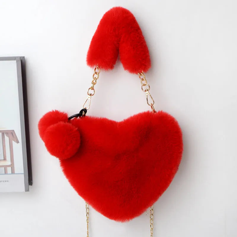 A soft plush heart-shaped women's handbag with a zipper and a detachable shoulder strap in a choice of 14 colours.