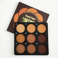 Dark matte makeup palette open showing nine colours with a repair disk