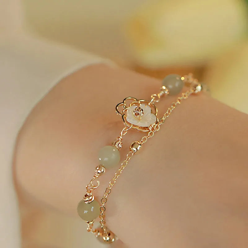 Yellow gold electroplated copper bracelet with shell flower butterfly and Hetian jade design for women