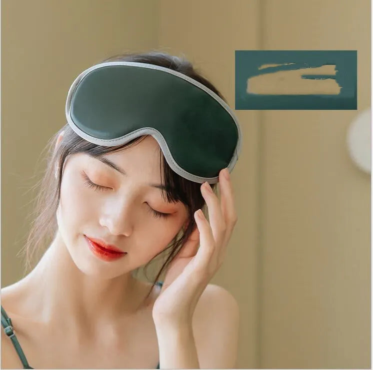 Pink and green portable eye SPA massage goggles with suede shell on a grey background.