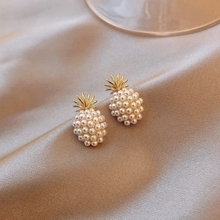 Korean style gold pineapple starfish pearl earrings made from electroplated alloy with inlaid stones.