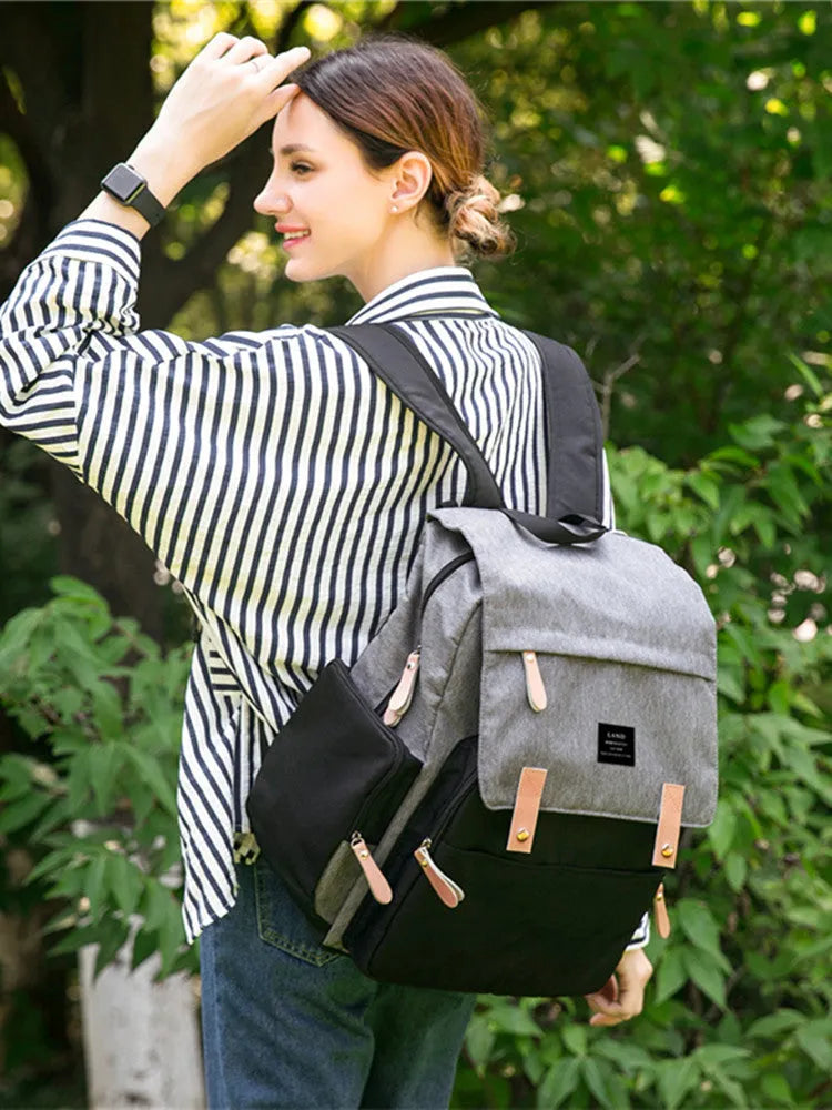 LAND Mommy large grey Oxford cloth diaper backpack with changing mat, showing front compartments.