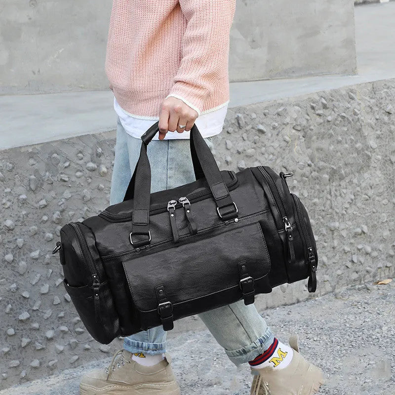 Black travel holdall bag with shoe compartment showing dimensions 52cm × 19cm × 27cm