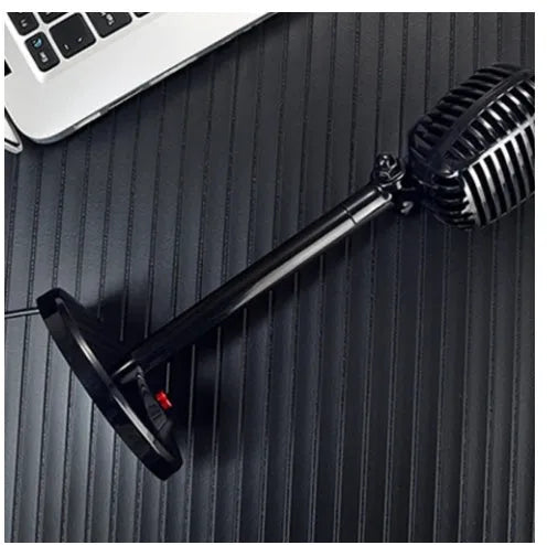 Black USB desktop computer microphone with adjustable stand on a desk.