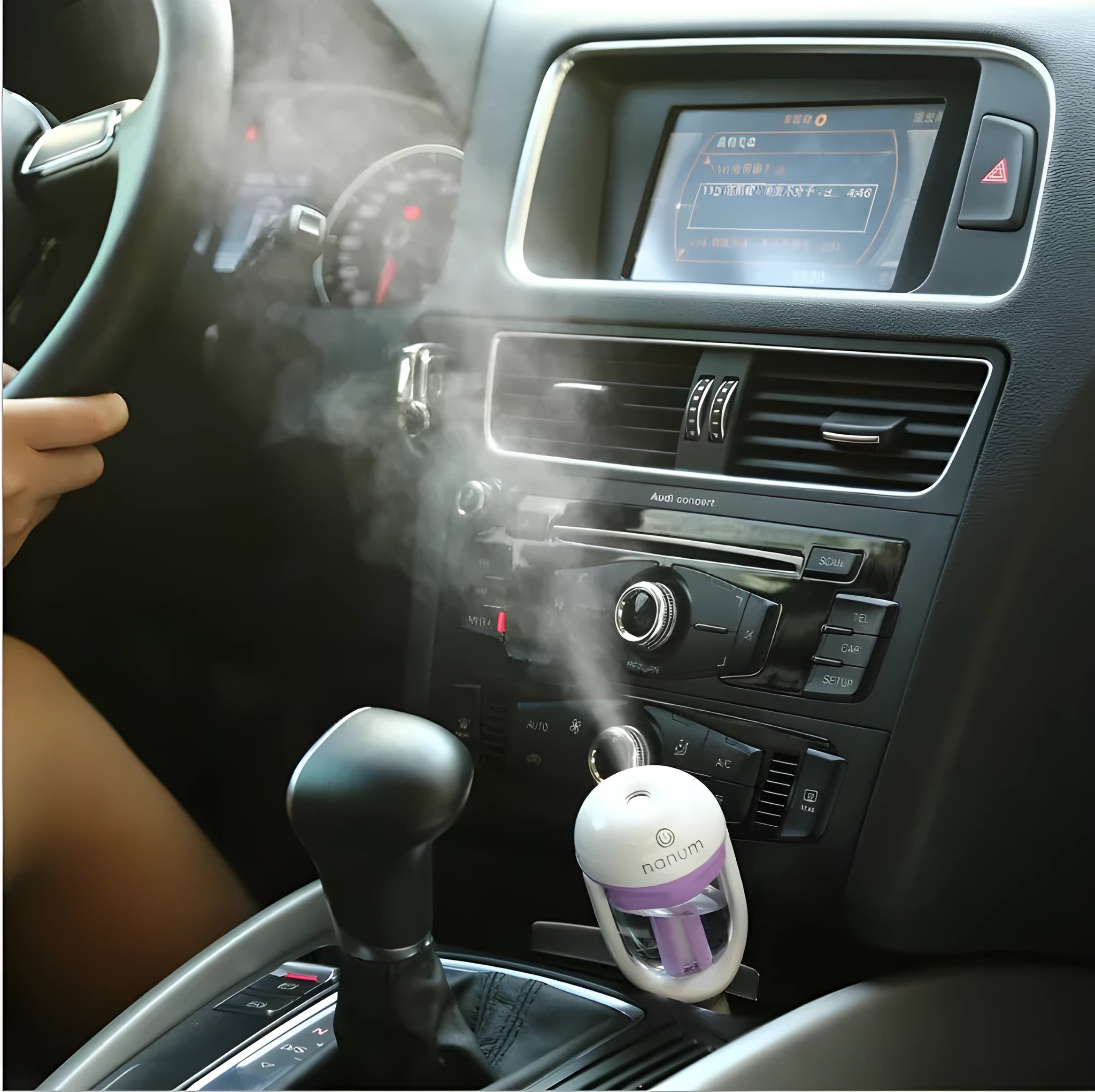 Compact blue car humidifier air purifier with essential oil diffuser function on car dashboard
