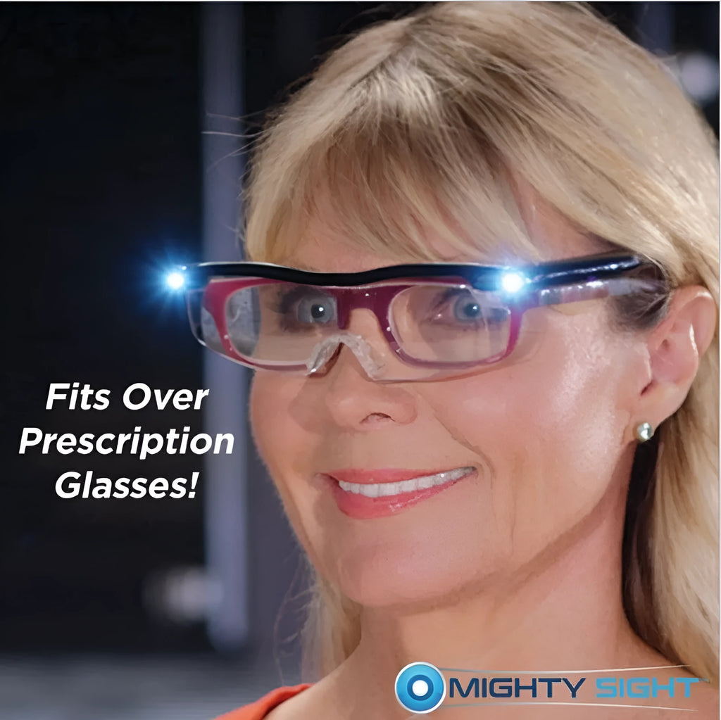 Transparent black USB LED reading glasses with integrated lighting, shown on reading material