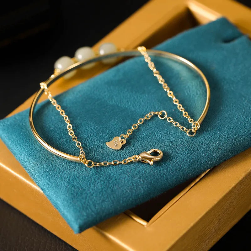Women's Hetian jade bracelet with gold inlay detail, shown in single, double, and three bead versions.
