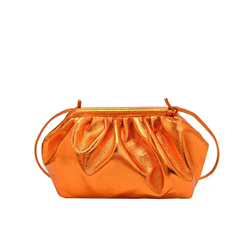 Shell-shaped crossbody bag with hair clip shoulder strap showing multiple compartments including mobile phone pocket
