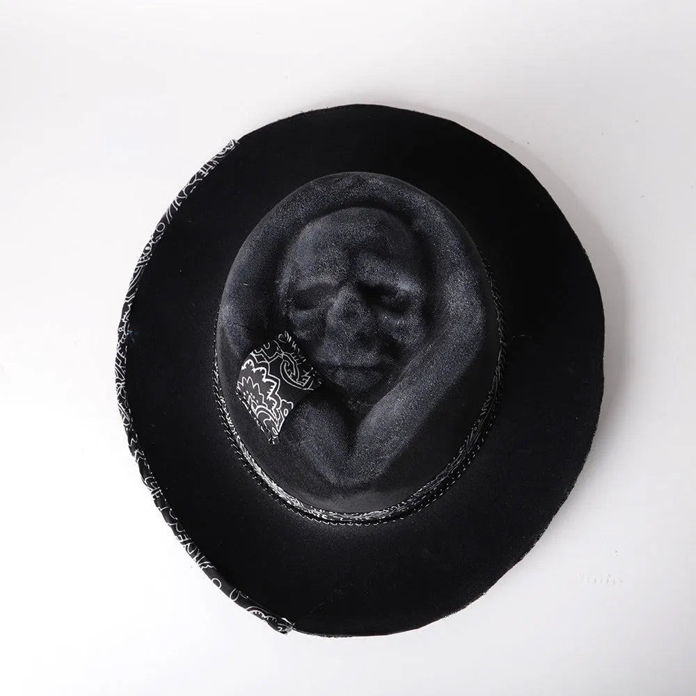 Handmade wool felt Halloween hat with a pointed conical crown in a skull design.