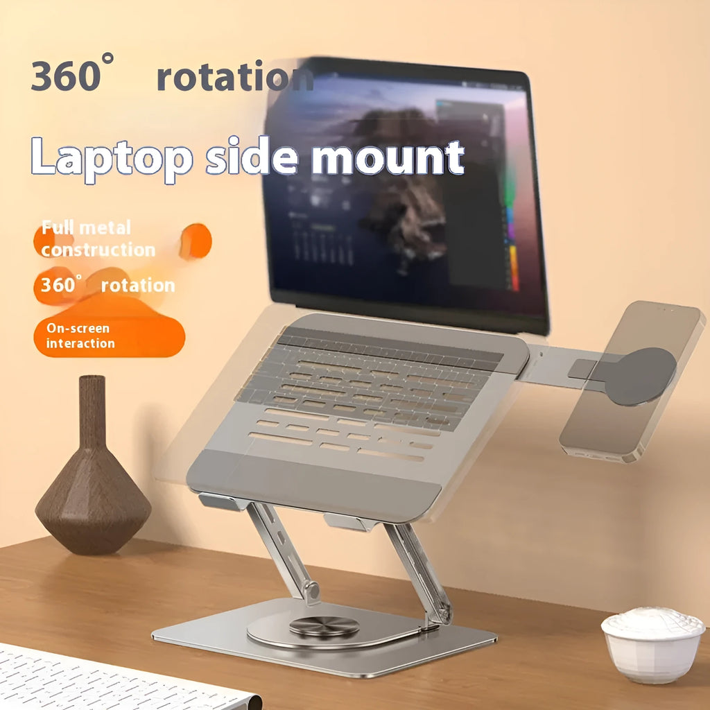 Silver carbon steel laptop stand with 360-degree rotation and a side-mounted magnetic phone holder.