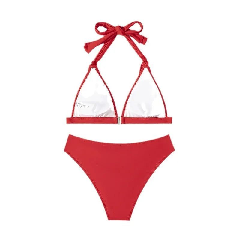 Women's red lace-up halterneck bikini set with split design and matching shorts for swimming