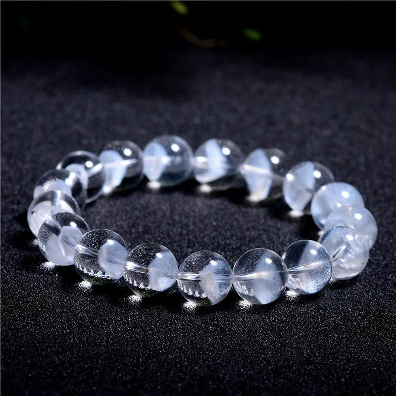 White crystal pyramid bracelet with natural ghost charm and Ruyi symbol detail on wrist