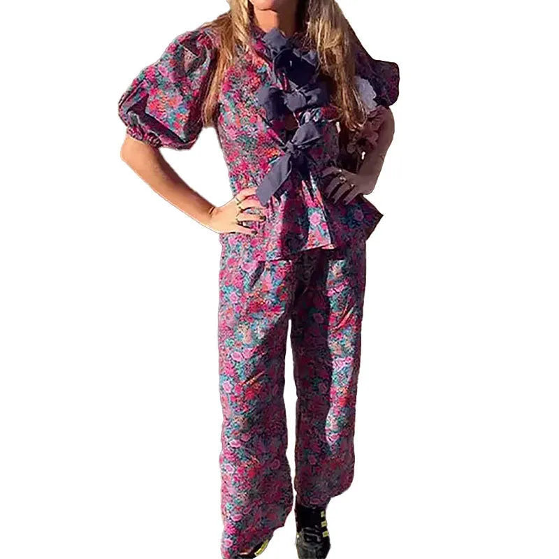 Women's floral print trousers suit with tie-neck top and puff sleeves