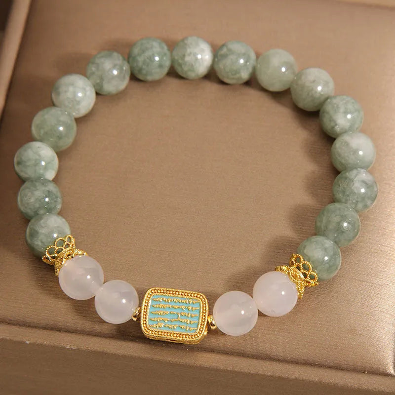 Oil green emerald crystal bracelet for women with five scripture charms on a white background.