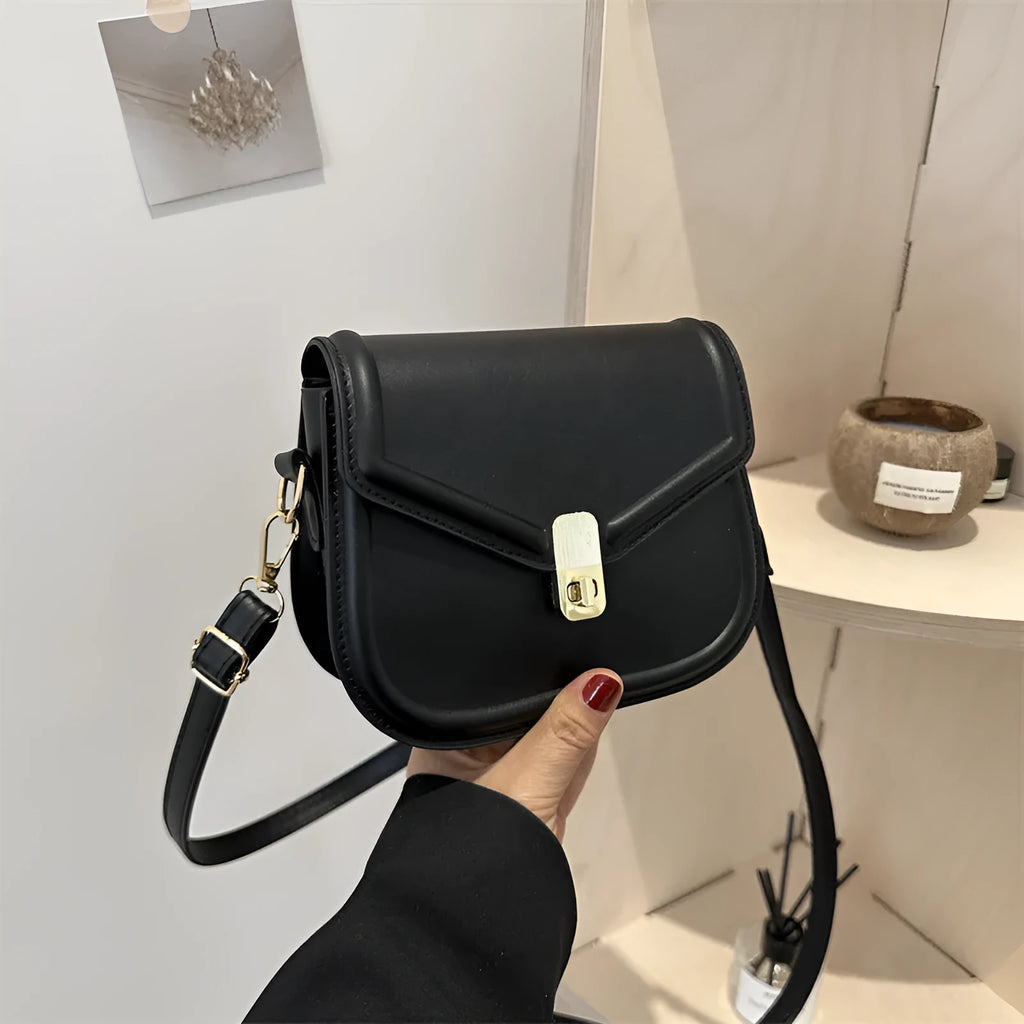 Soft textured PU shoulder messenger bag in horizontal square clamshell design.