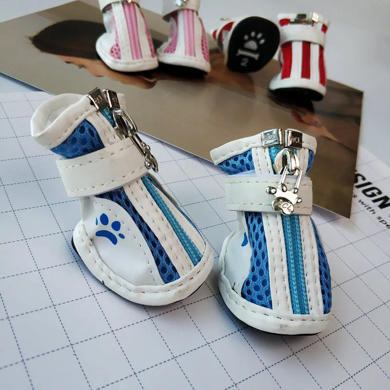 Four blue cloth dog shoes for small dogs with front zipper closure on a white background.