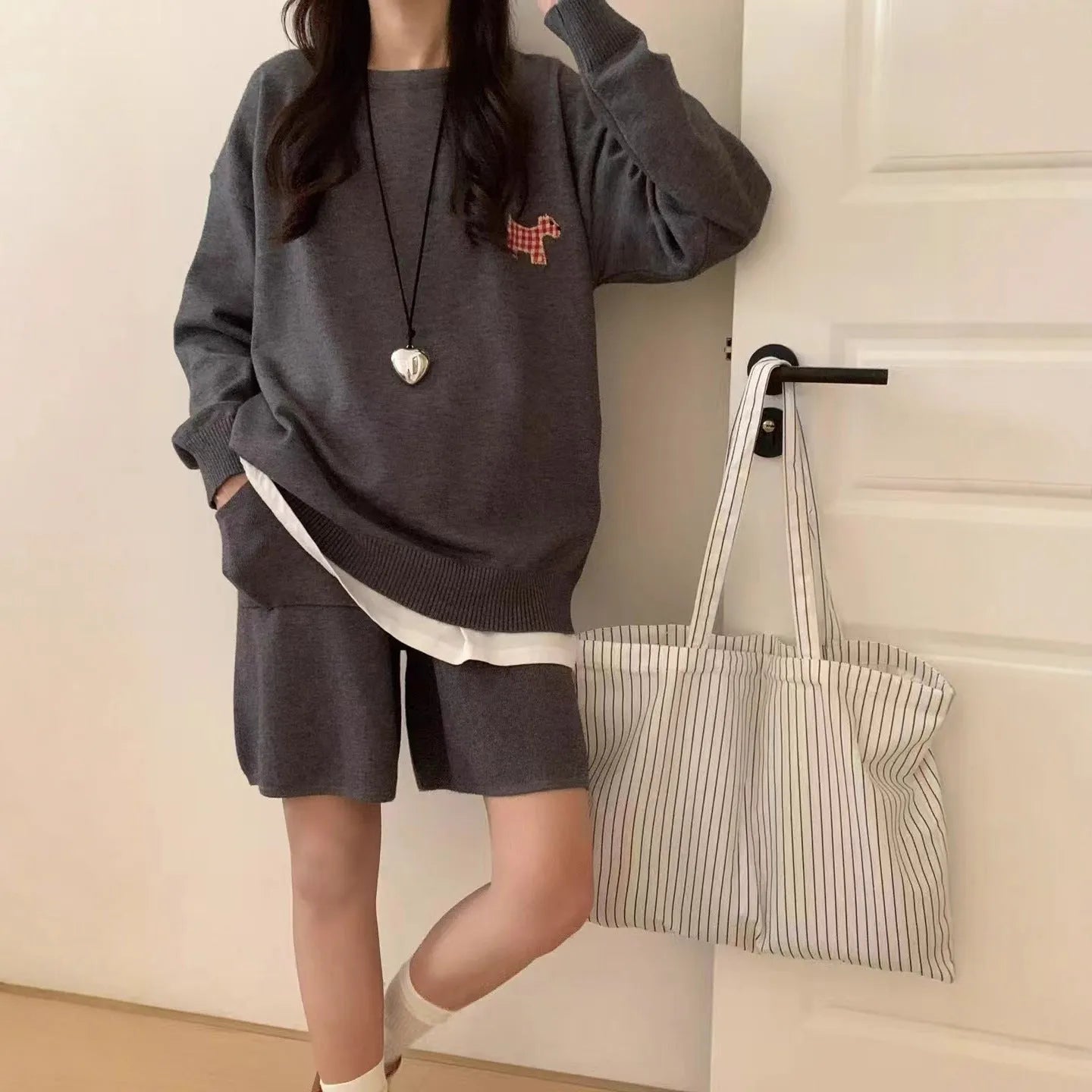Women's milk blue casual knitted sports suit with animal embroidery on top and matching shorts.
