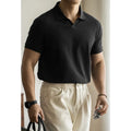 Man's blue American-style short-sleeved cotton blend polo shirt on a hanger.