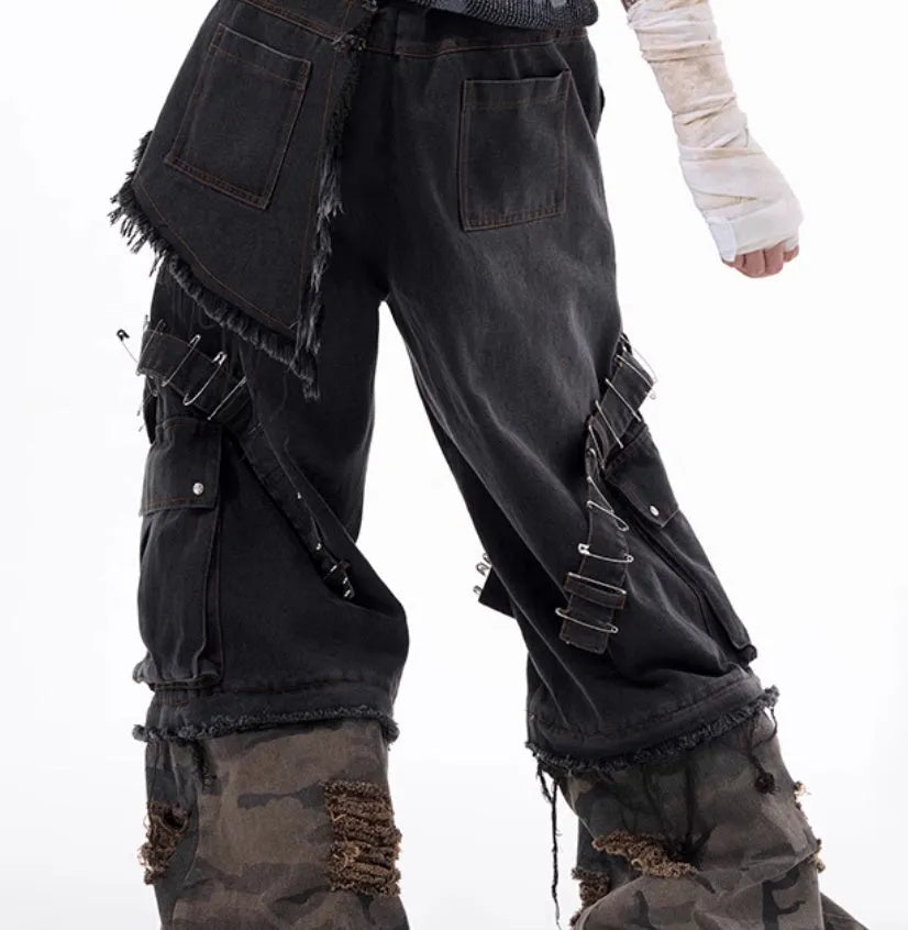 Men's grey camouflage print jeans with splicing panel construction and ribbon detail.