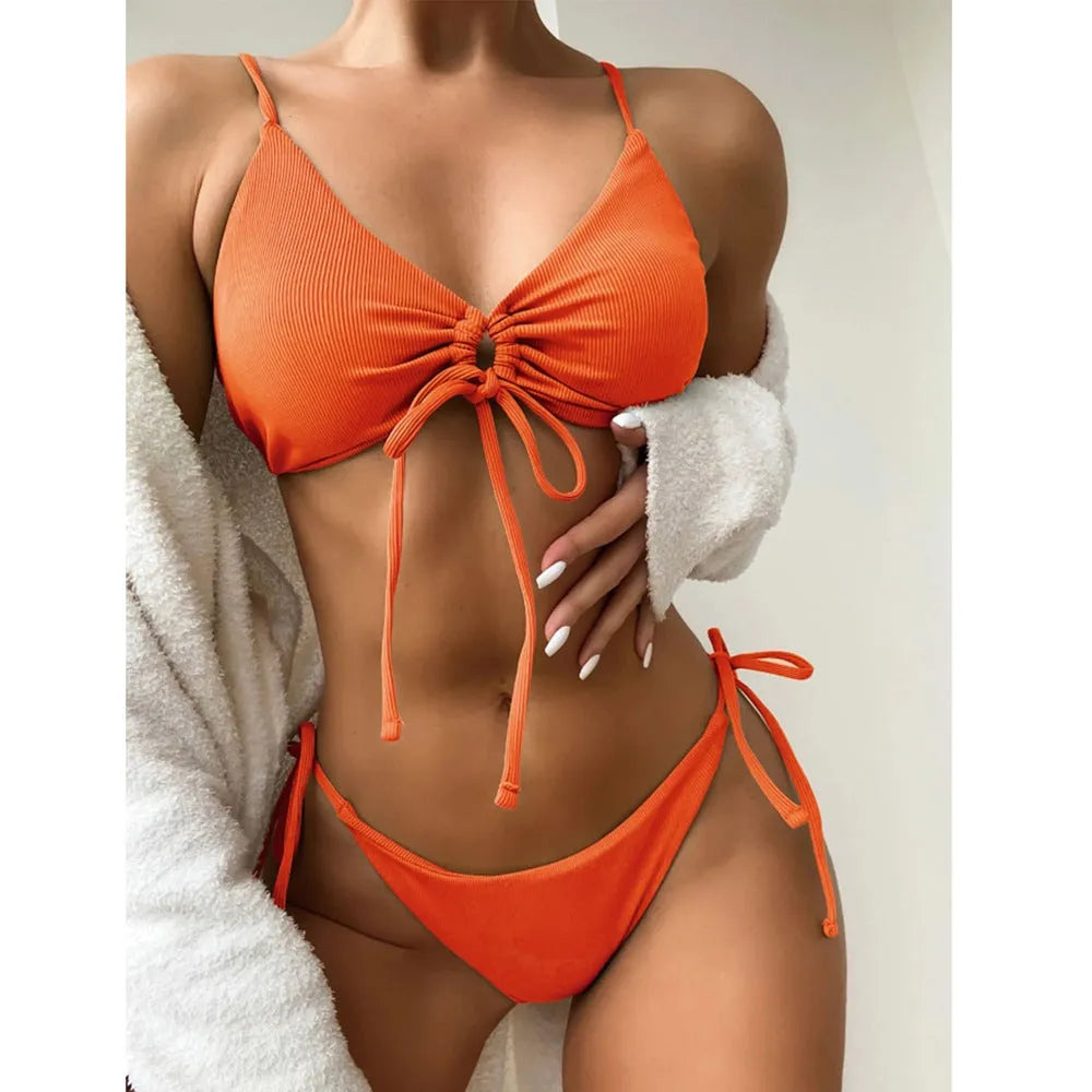 Women's solid color drawstring bikini set in backless brief style made of quick-drying nylon and spandex