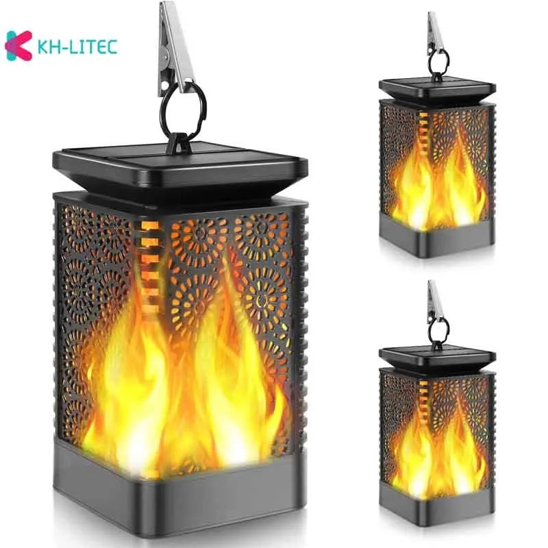 Set of four black solar-powered flame torch lights with flickering LED effect for garden pathways