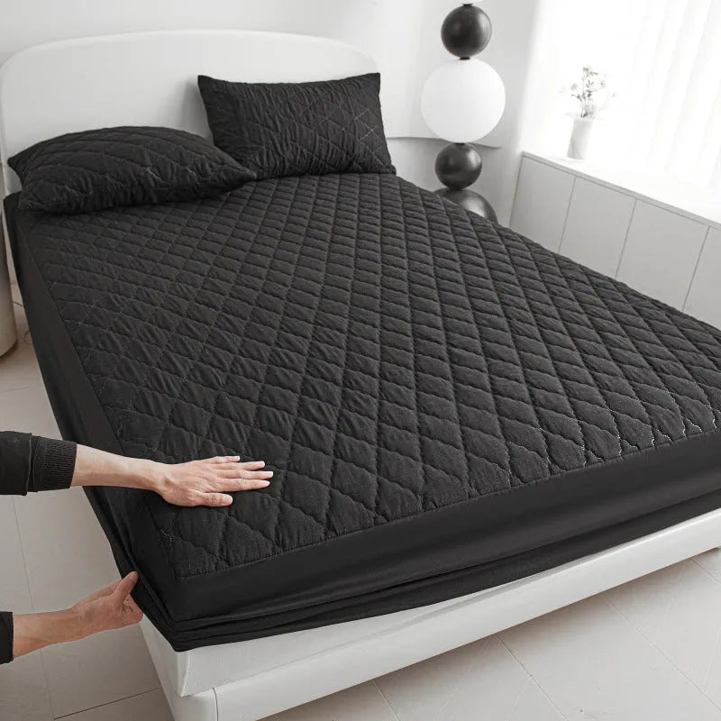 Diamond lattice quilted waterproof mattress protector in bamboo fibre shown on bed