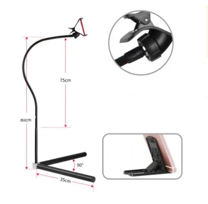 Black bedside phone holder with universal mobile phone bracket and adjustable overhead support shelf positioned next to bed
