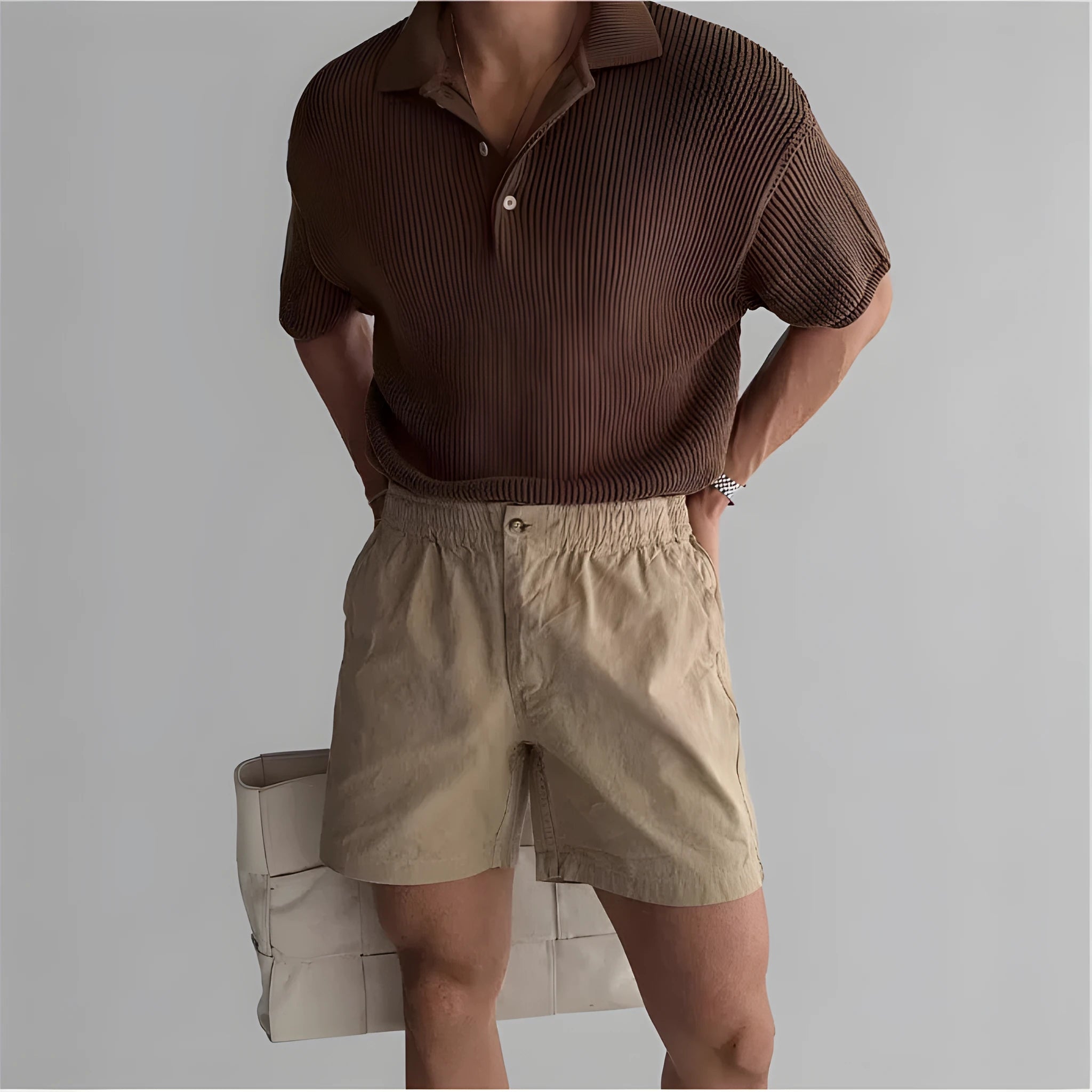 Men's loose-fit cotton sports shorts in black, shown on a hanger.
