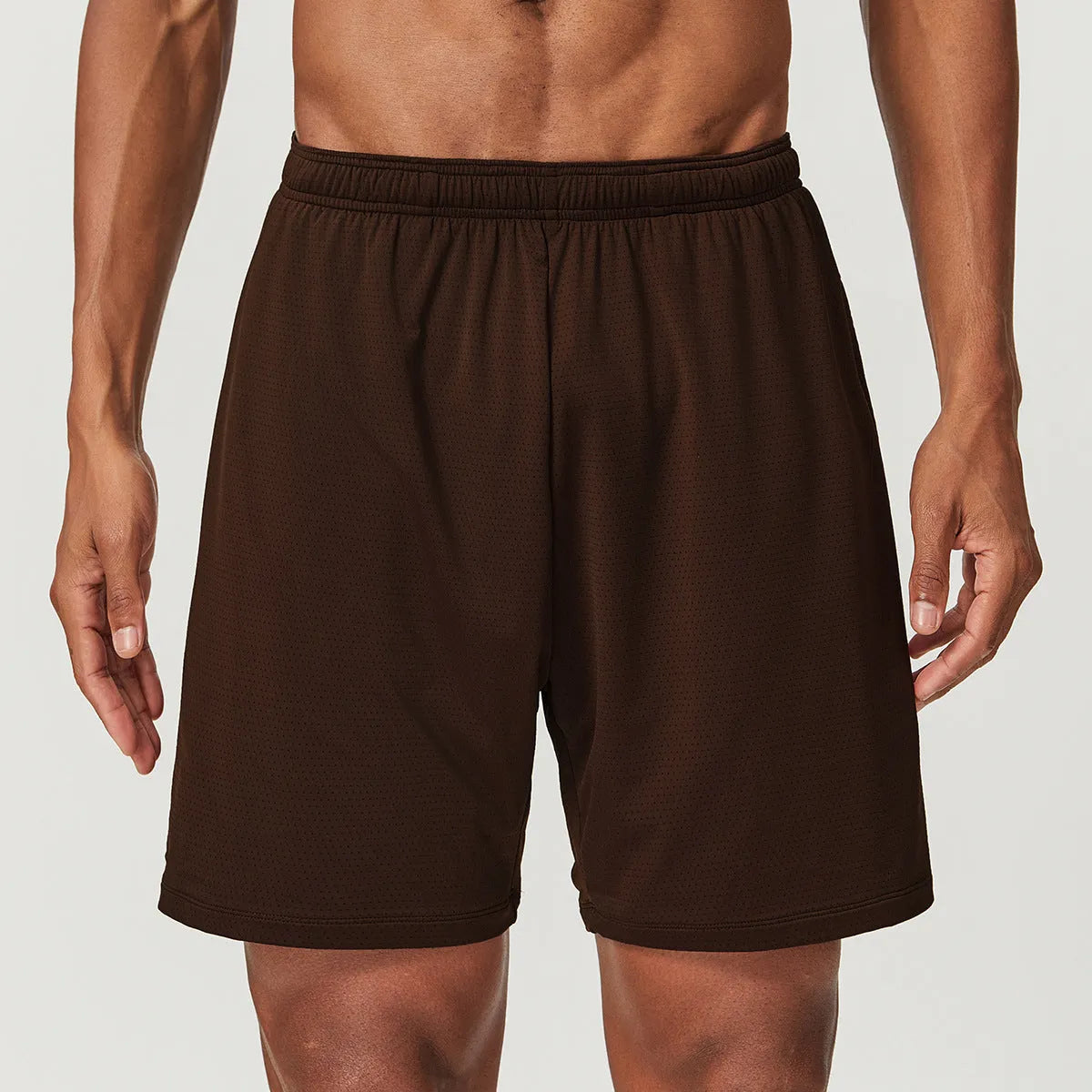 Man's quick-drying athletic shorts in khaki colour, showing double-layer construction and mid-waist fit.