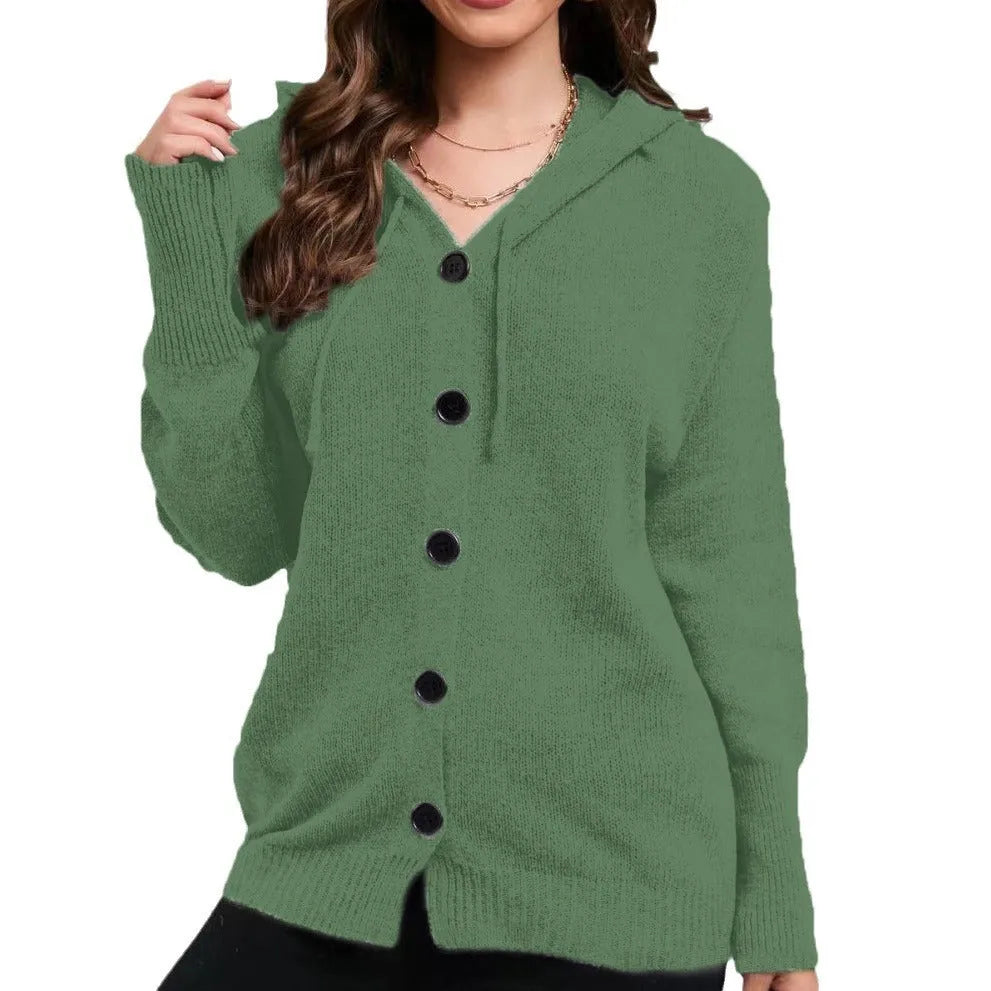 Woman wearing a thick, loose-fit grey hooded cardigan sweater with long sleeves.