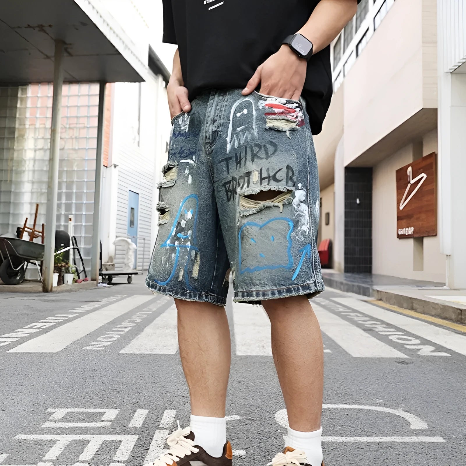 Men's blue distressed denim shorts with straight leg cut and zipper fly