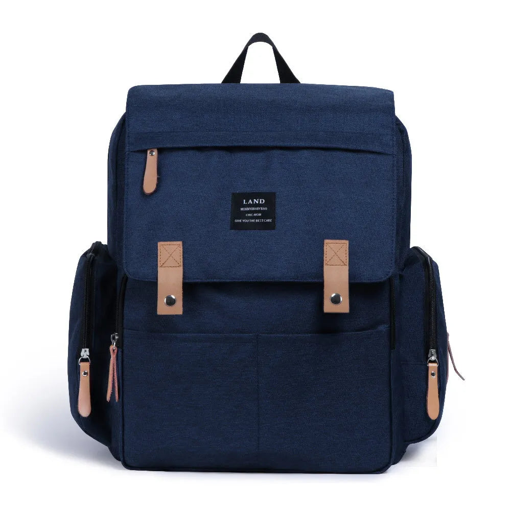 LAND Mommy large grey Oxford cloth diaper backpack with changing mat, showing front compartments.