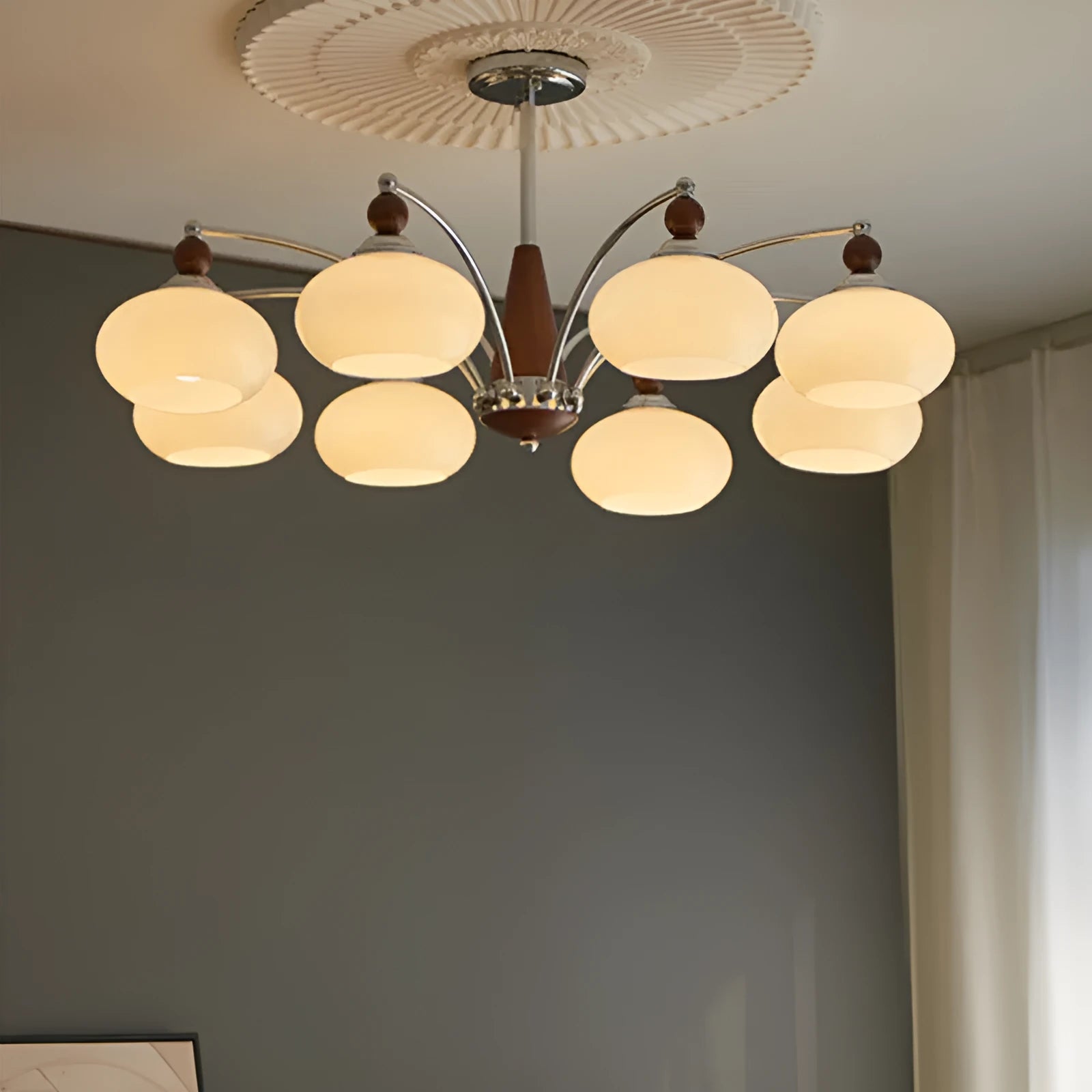 Traditional persimmon glass and chrome chandelier with multiple light heads for a dining room.