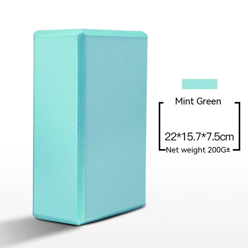 High-density EVA yoga block in violet colour next to a pink block with a cartoon print design.
