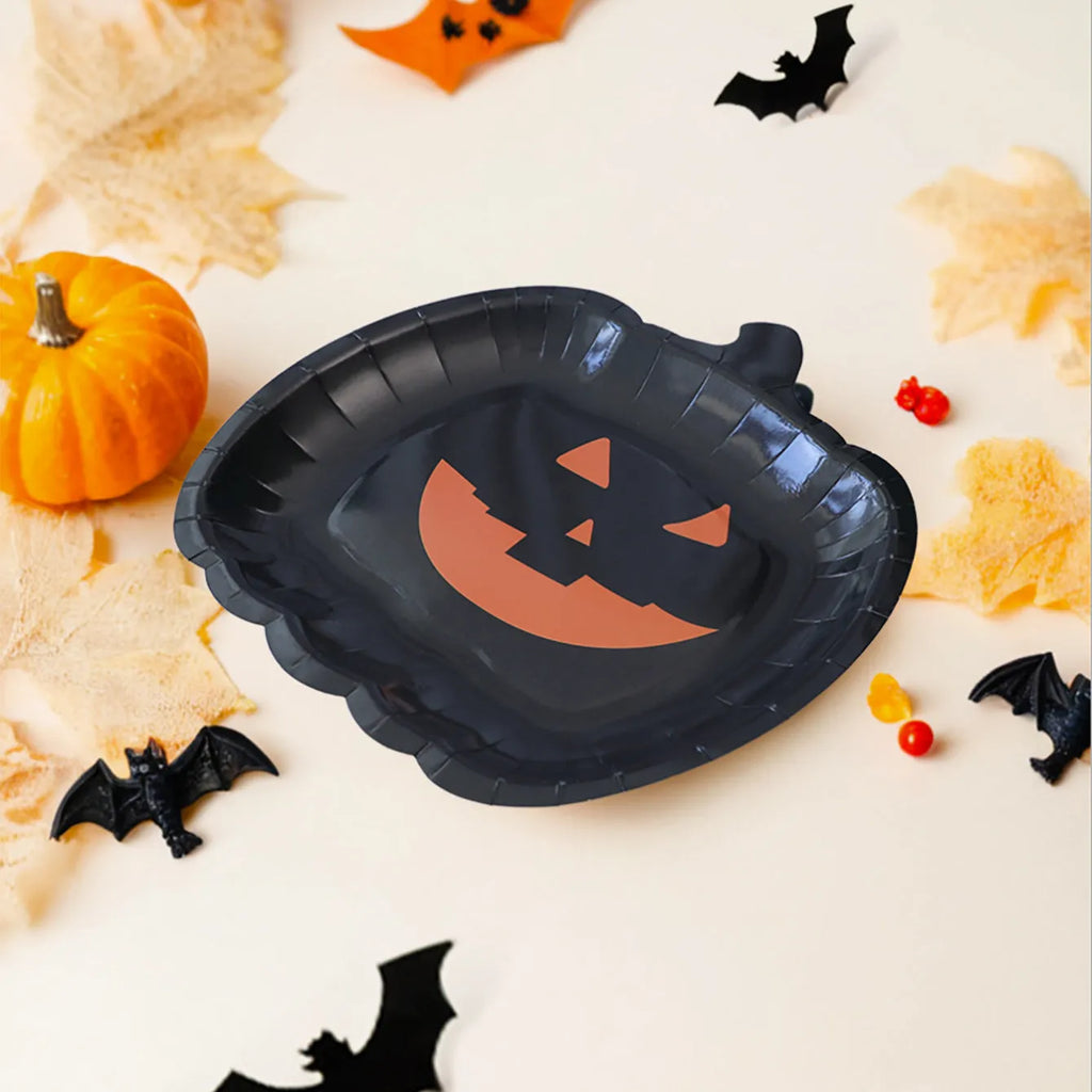 Set of black disposable Halloween paper plates with orange pumpkin design, 9 inches in diameter.