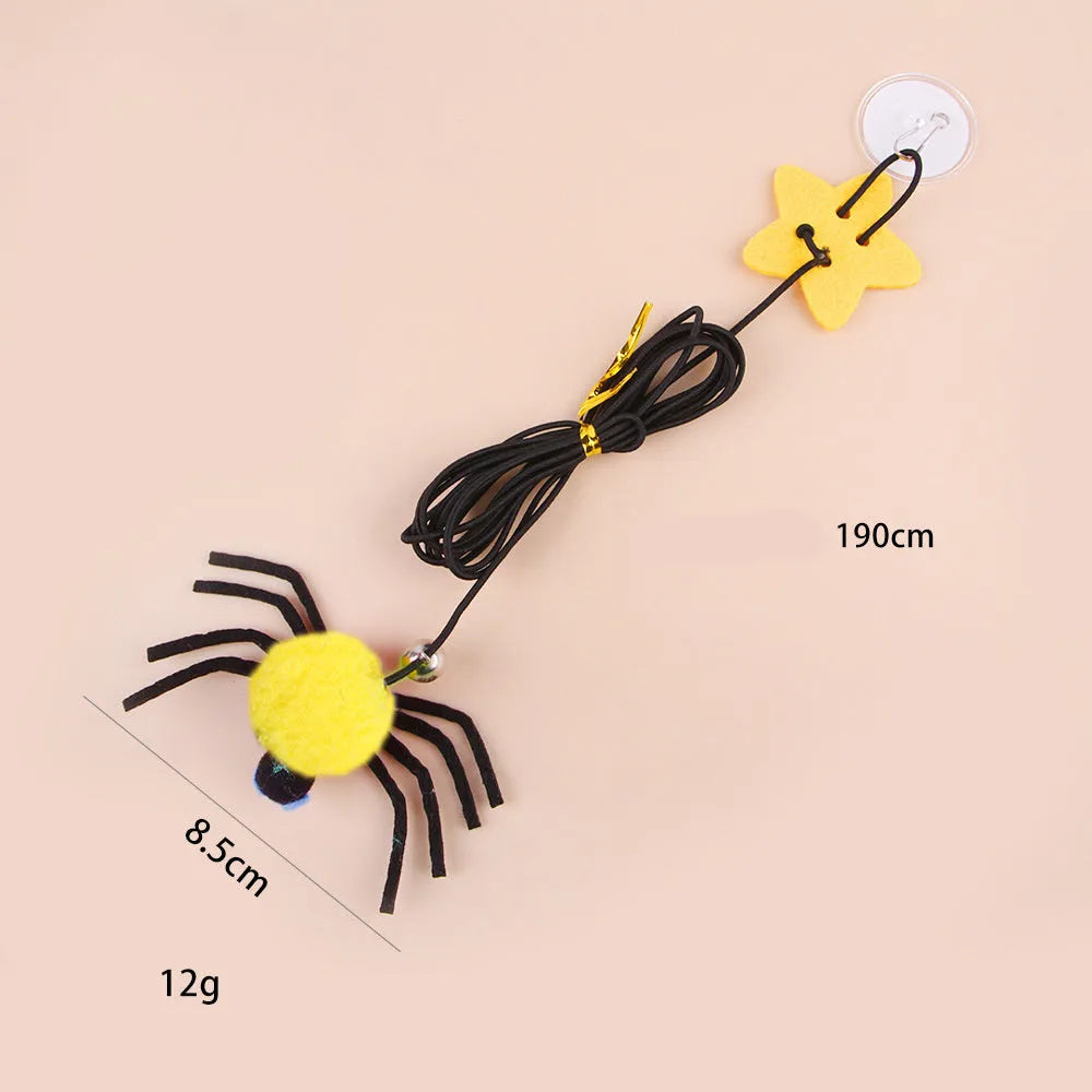 Red cat door hanging toy with elastic rope, feathers, bell, and spider attachments for interactive play