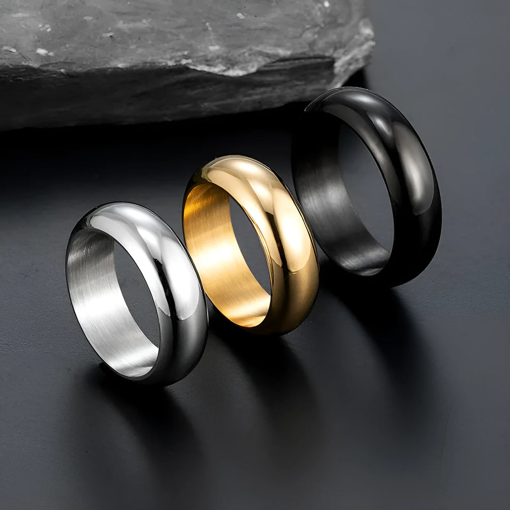 Glossy electroplated titanium steel ring in gold colour on a grey background.