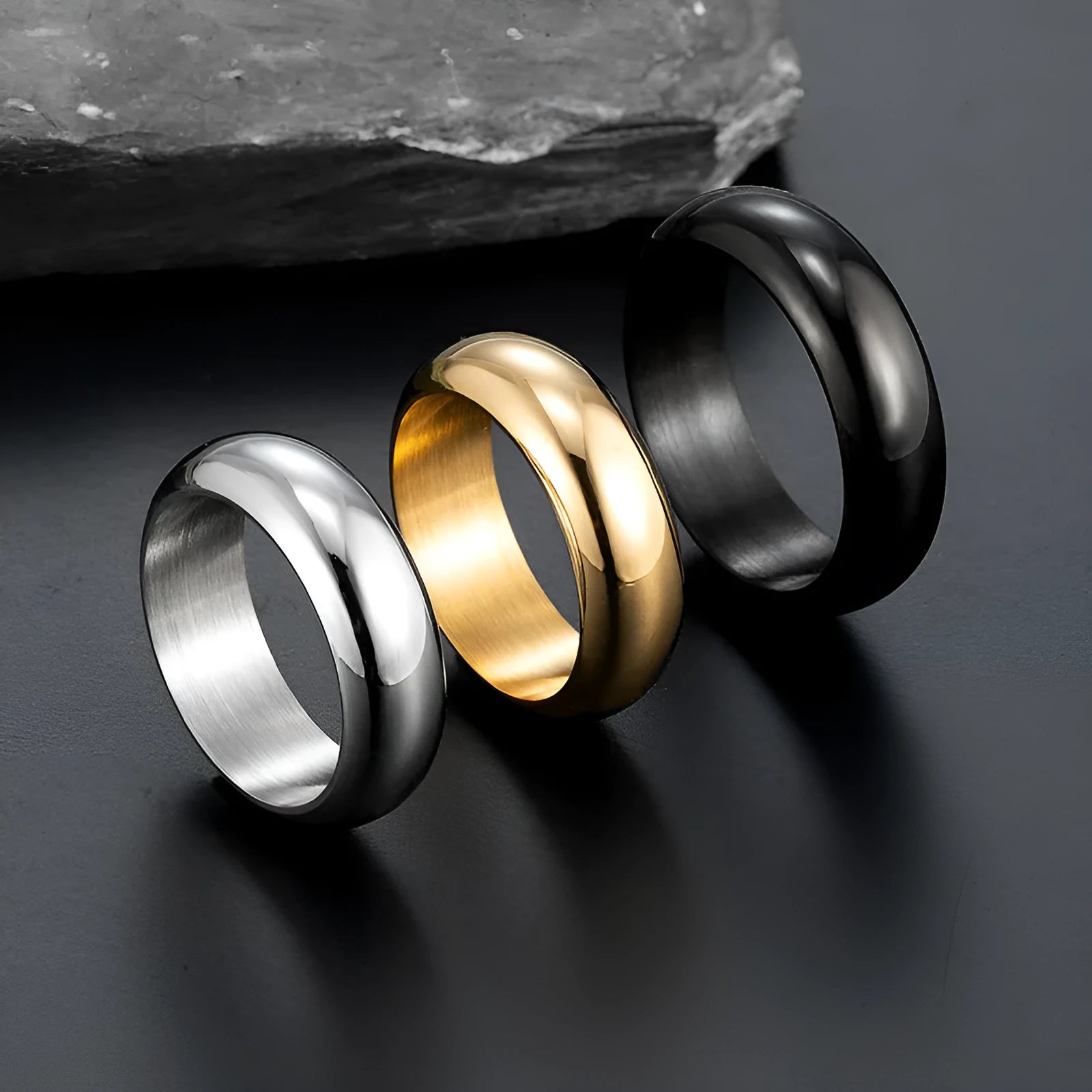 Glossy electroplated titanium steel ring in gold colour on a grey background.