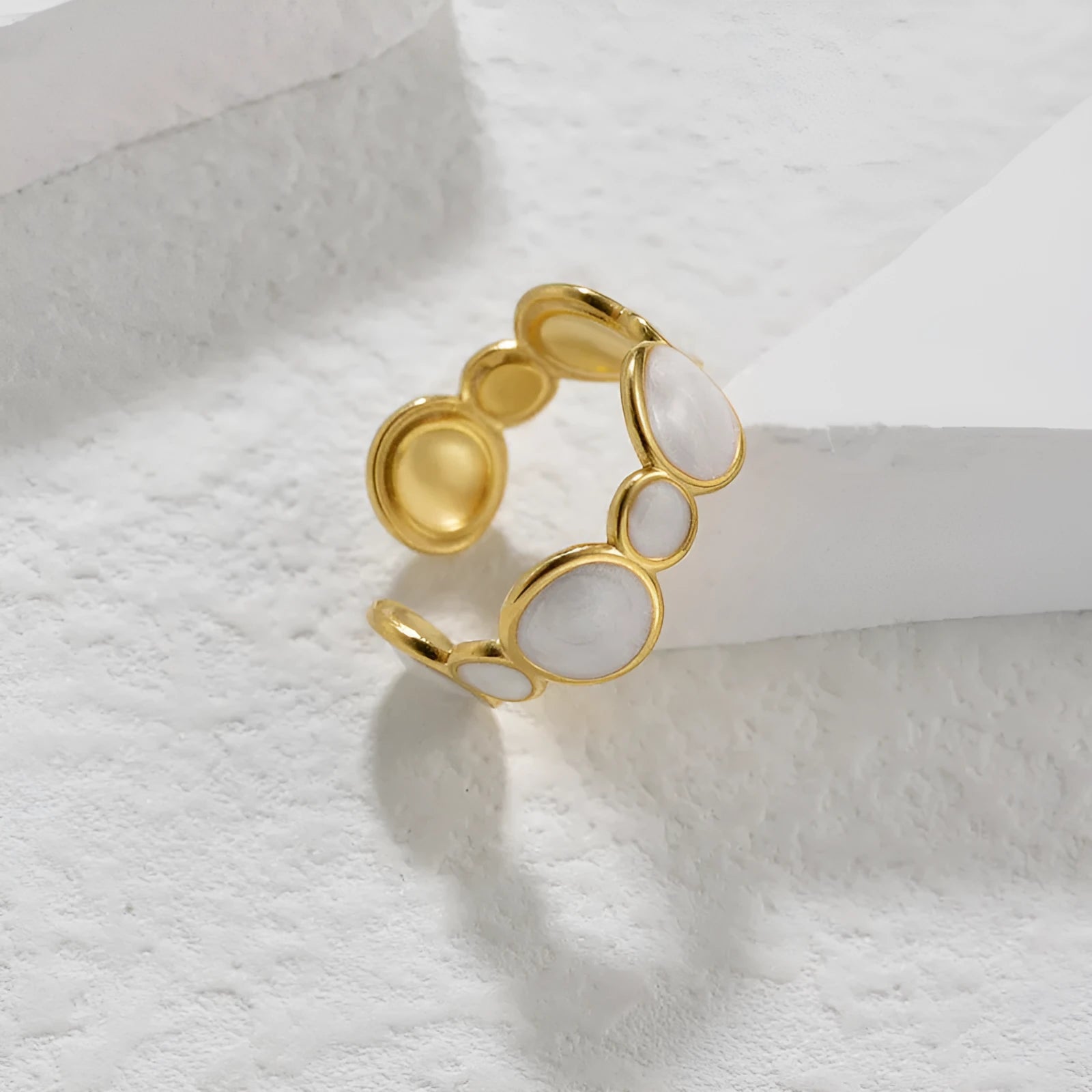 Silver geometric adjustable ring on a grey background.