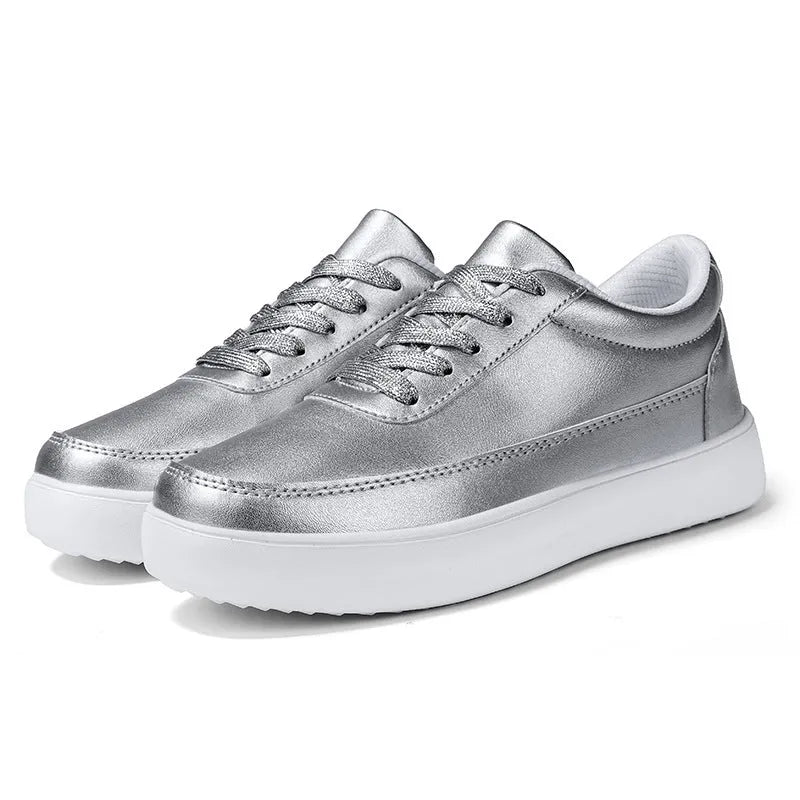 Women's white leather flat casual lace-up shoes on a neutral background.