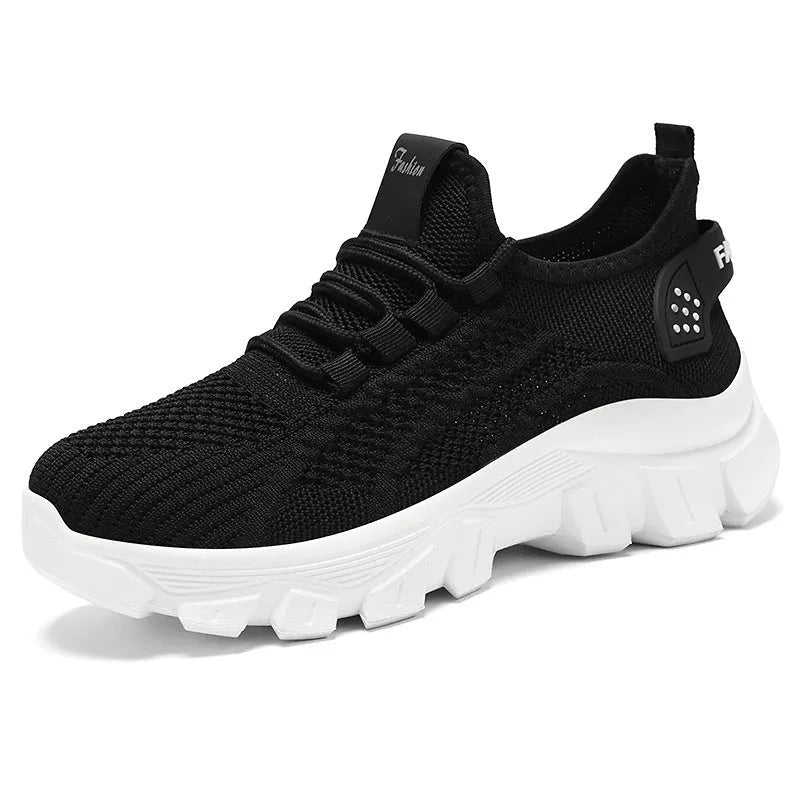 Men's white Flyknit sneakers with a thick PVC sole and round toe on a plain background.