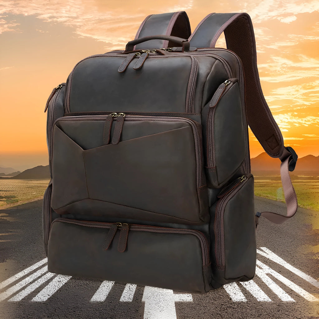 Dark brown genuine leather 17-inch laptop backpack with double shoulder straps and embossed finish