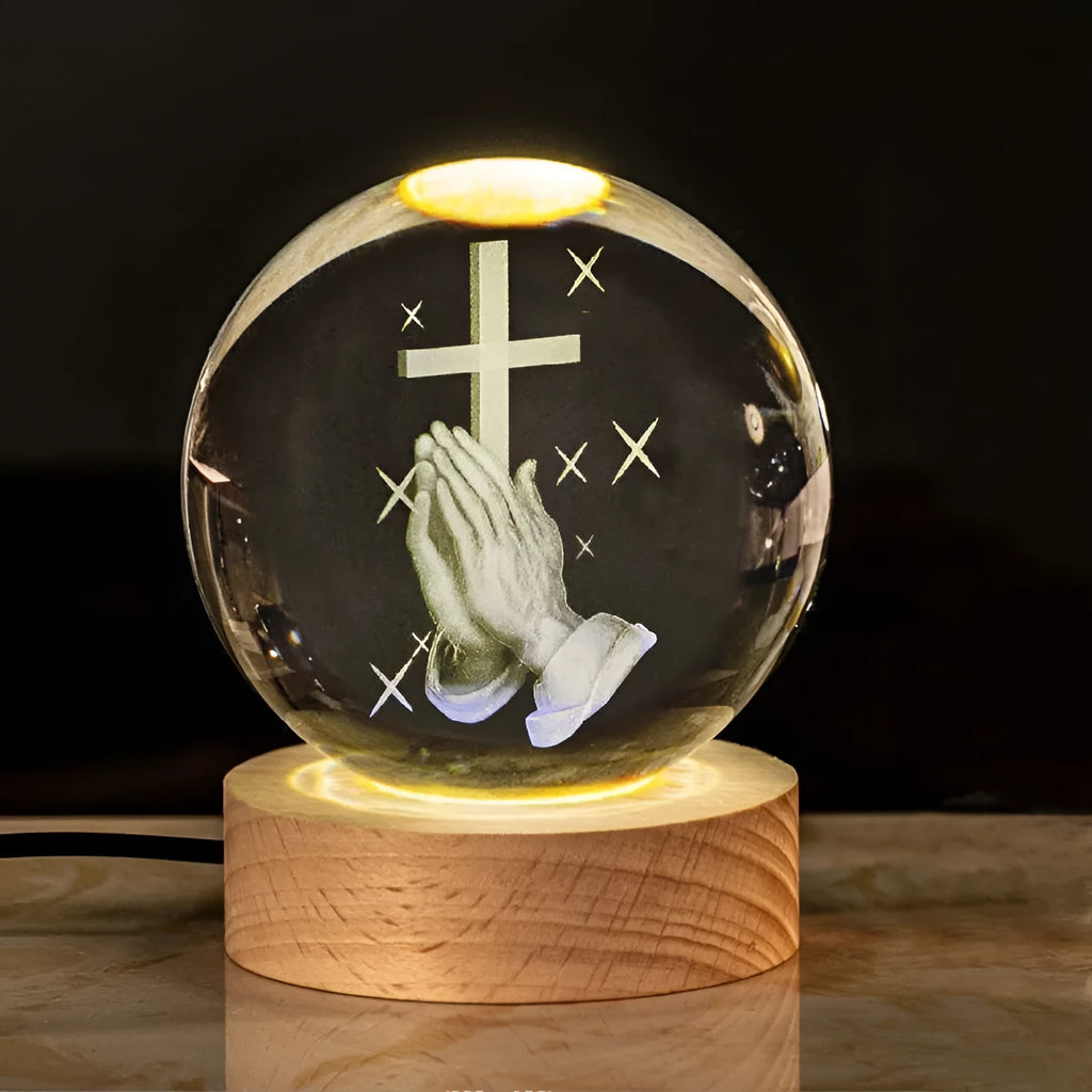 White crystal ball desk lamp on wooden base with warm light, showing religious symbol options.