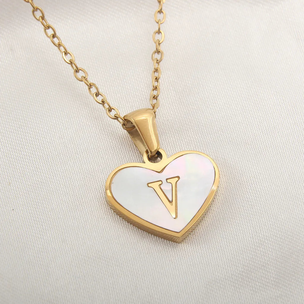 Gold plated heart-shaped necklace with white shell pendant on adjustable stainless steel chain