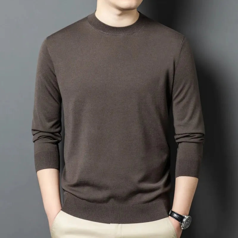 Men's round neck wool pullover sweater in a neutral colour with long sleeves, laid flat.